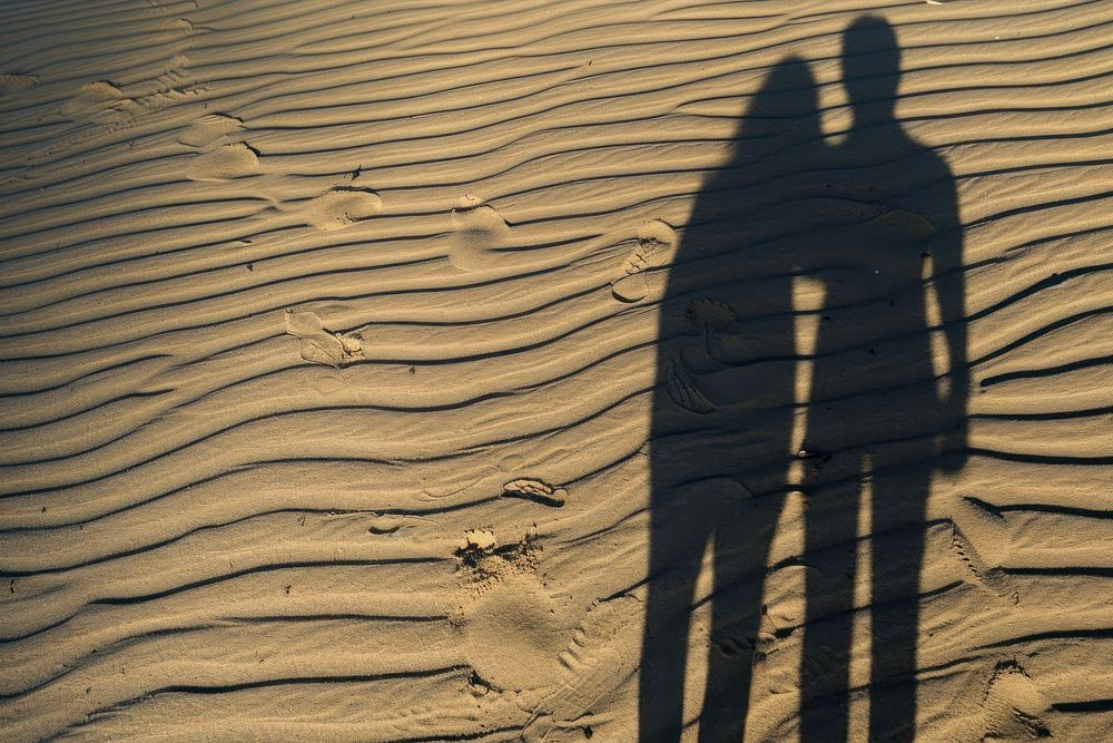 Couple shadow on sand backgrounds outdoors nature.