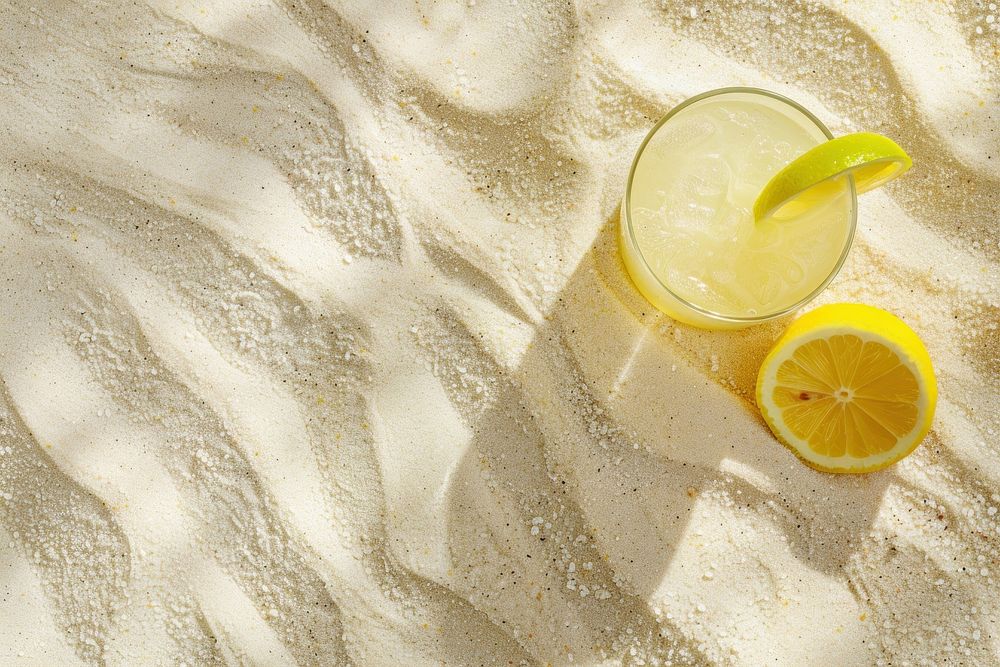 Lemon juice on sand backgrounds lemonade outdoors.