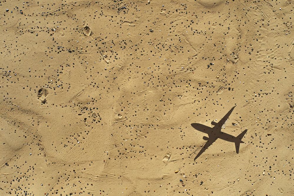 Plane icon drawing on sand backgrounds outdoors nature.
