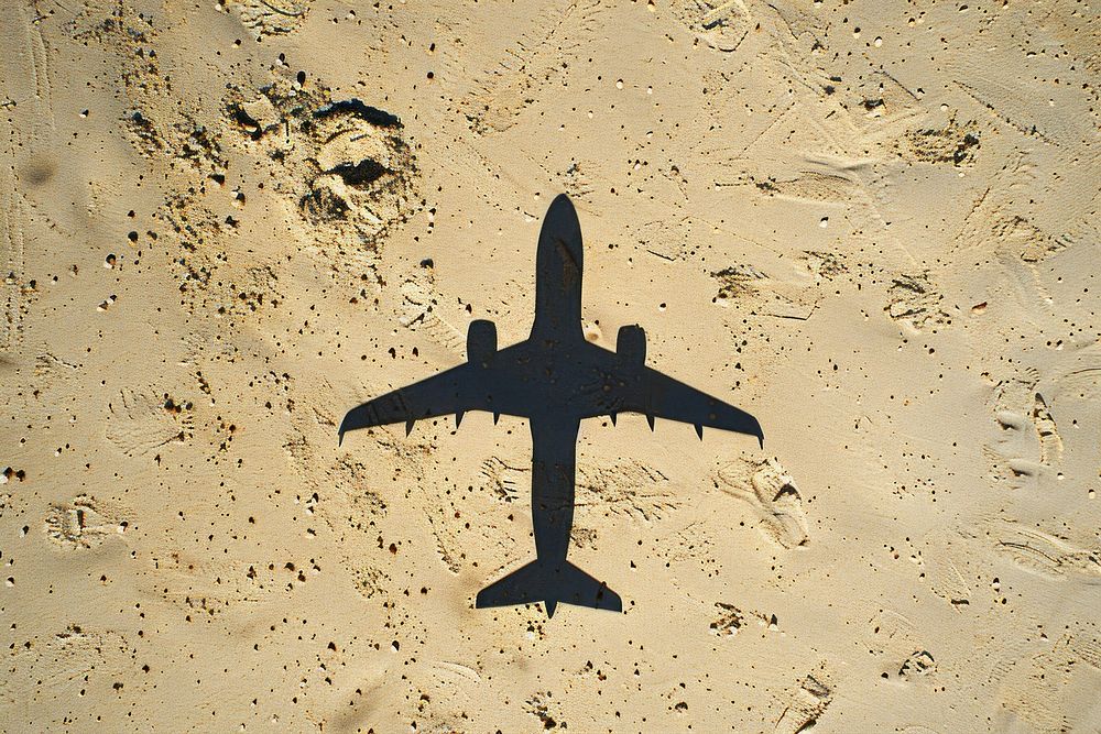 Plane shadow on sand airplane aircraft outdoors.