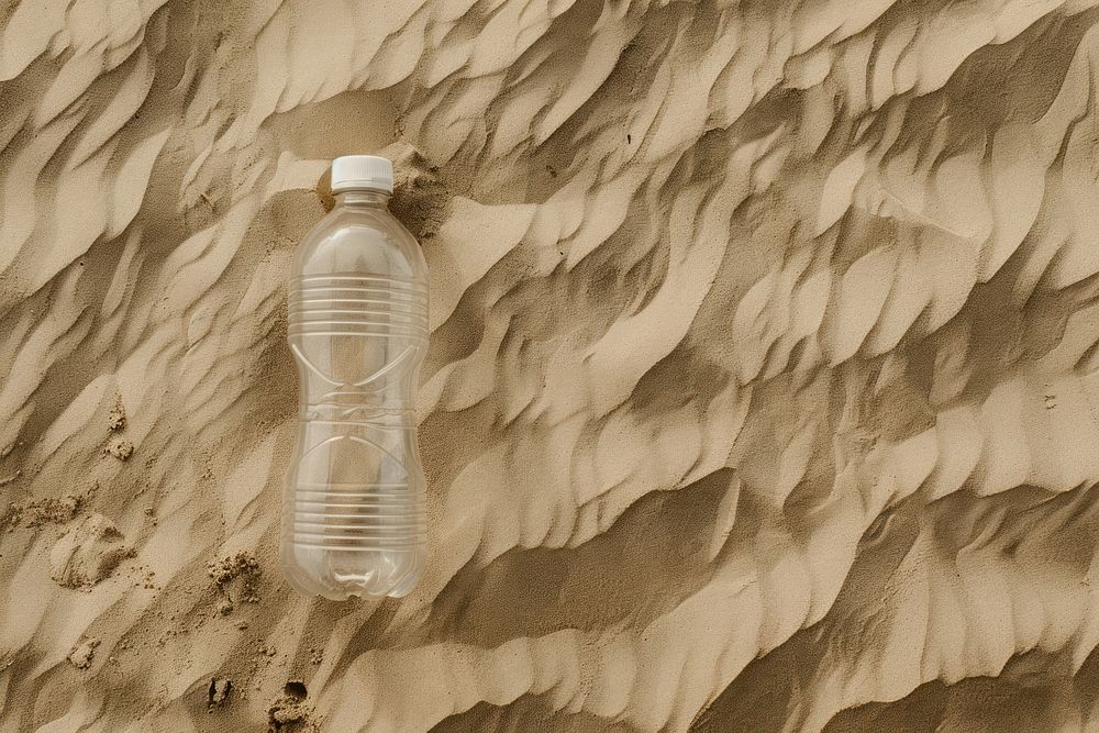 Plastic bottle on sand outdoors nature container.
