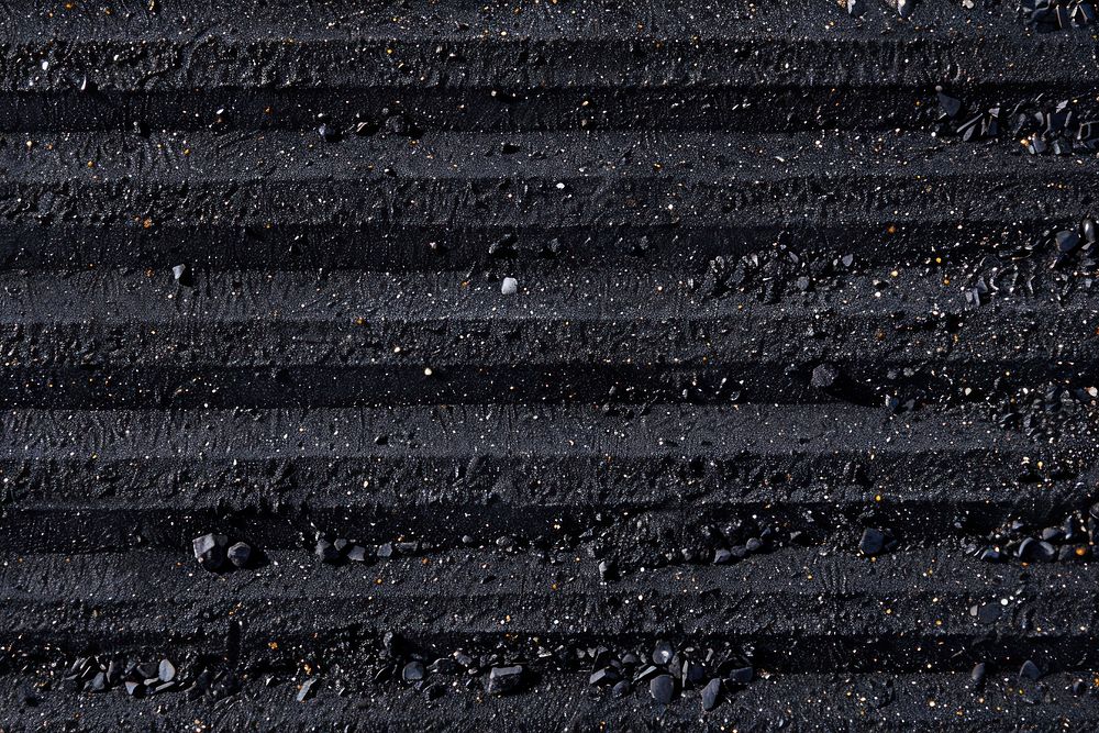 Striped patterns on black sand backgrounds asphalt soil.