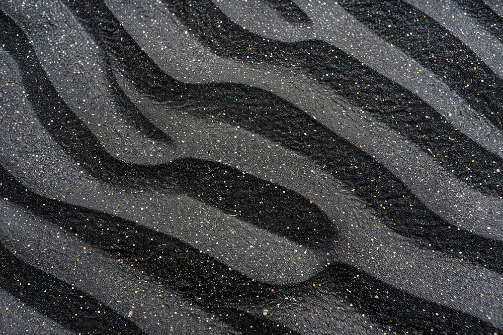 Striped patterns on black sand backgrounds asphalt floor.