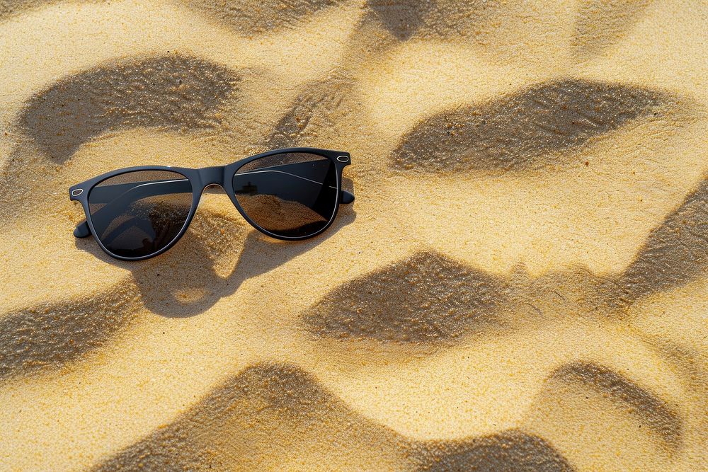Sunglasses on sand backgrounds outdoors nature.