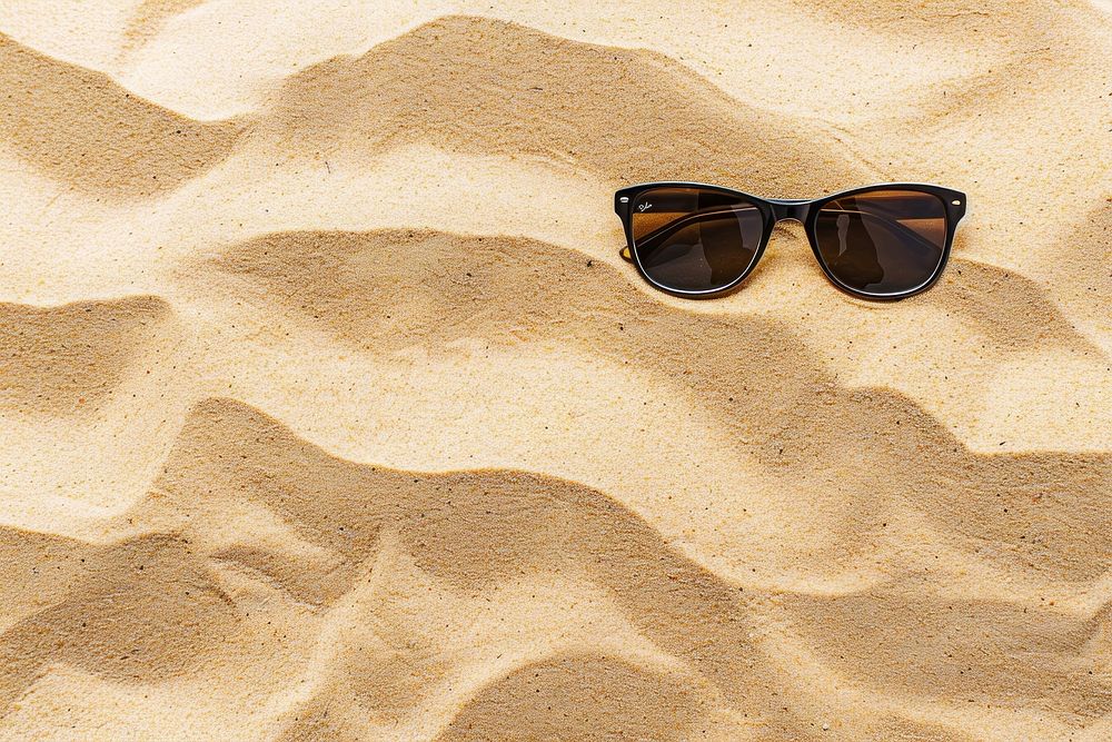 Sunglasses on sand backgrounds outdoors nature.