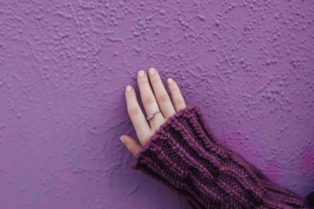 Hand finger purple wall.