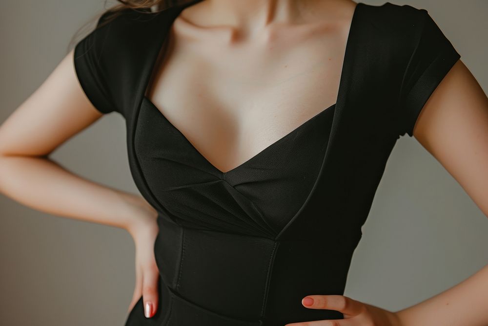Woman waist wearing black bodysuit dress adult undergarment.