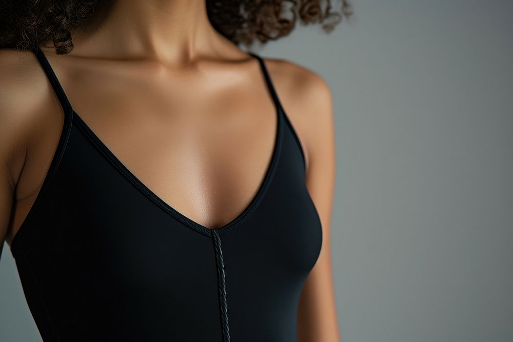 Woman wearing black bodysuit lingerie adult back.