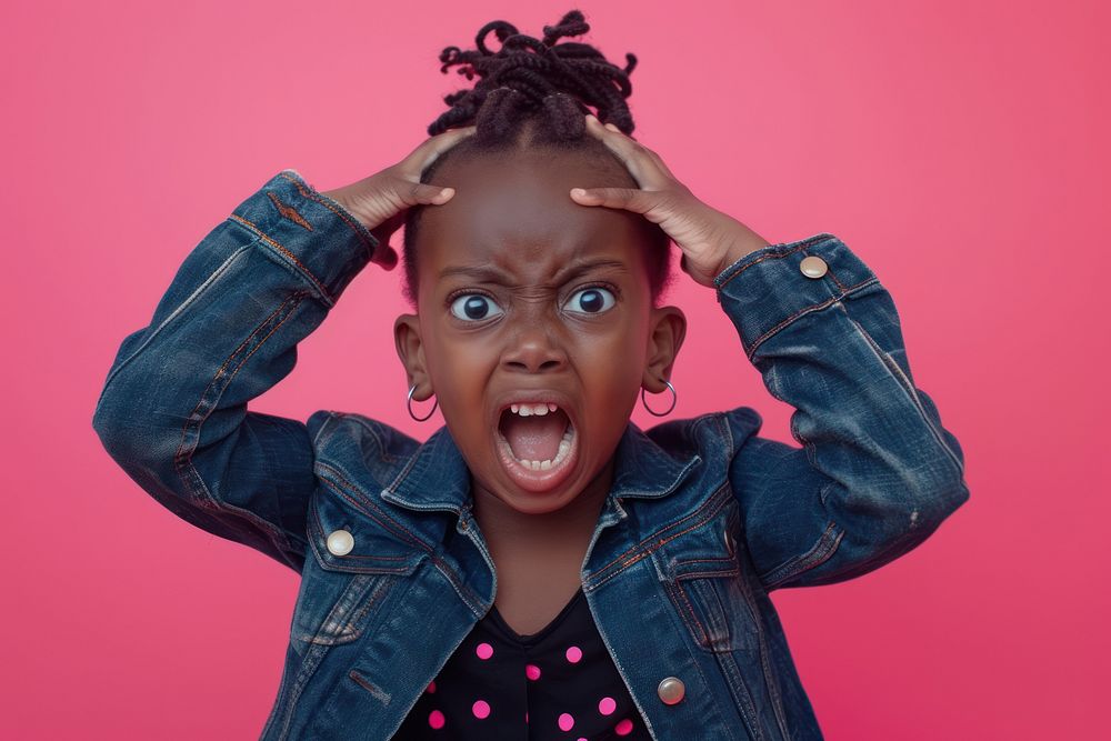 Cute black kid girl shouting portrait shock.