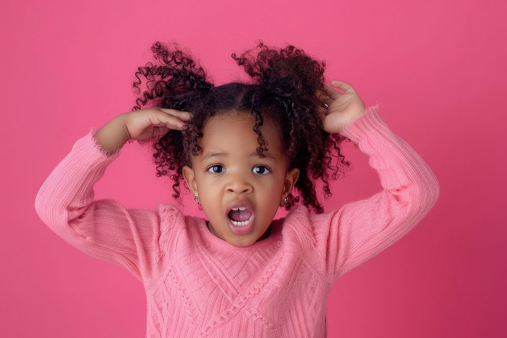 Cute black kid girl portrait pink head.