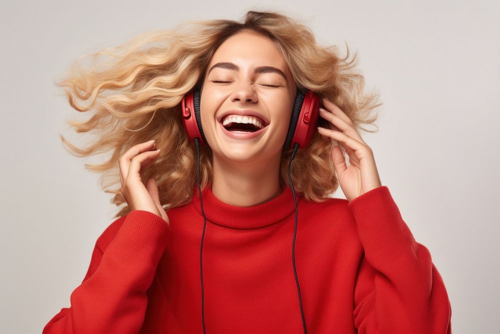 Young woman blond long hair enjoying happy and cheerful headphones listening laughing.