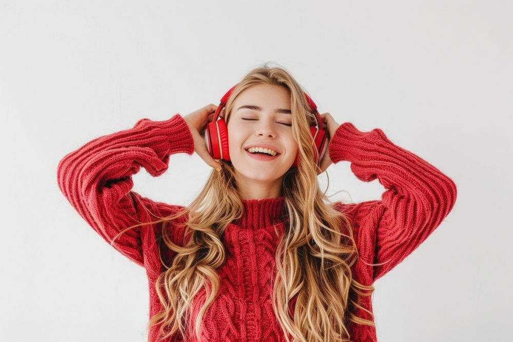Young woman blond long hair enjoying happy and cheerful sweater laughing smiling.