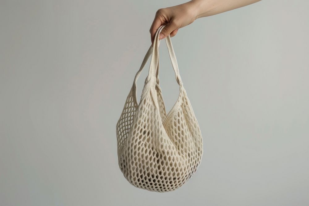 Hand holding net bag handbag accessories handicraft.