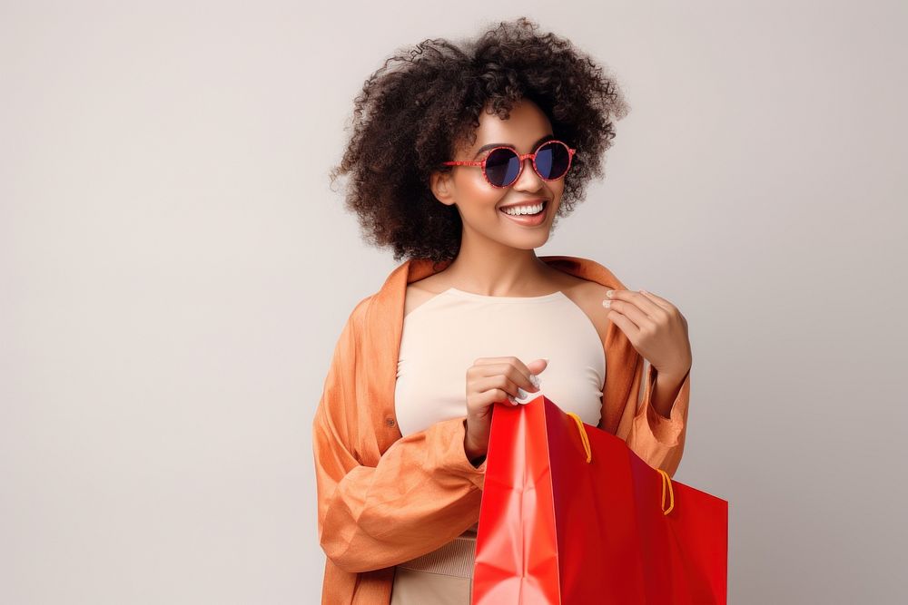 Hold shopping bags african woman smile sunglasses.