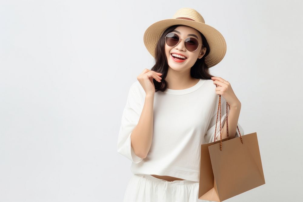 Asian woman holding shopping bag glasses handbag dress.