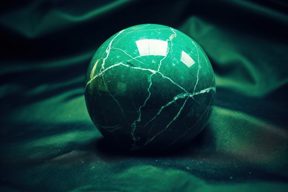 1 green marble on green background sphere ball darkness.