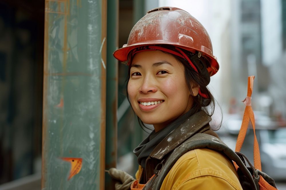 A smiling female construction worker hardhat helmet architecture.