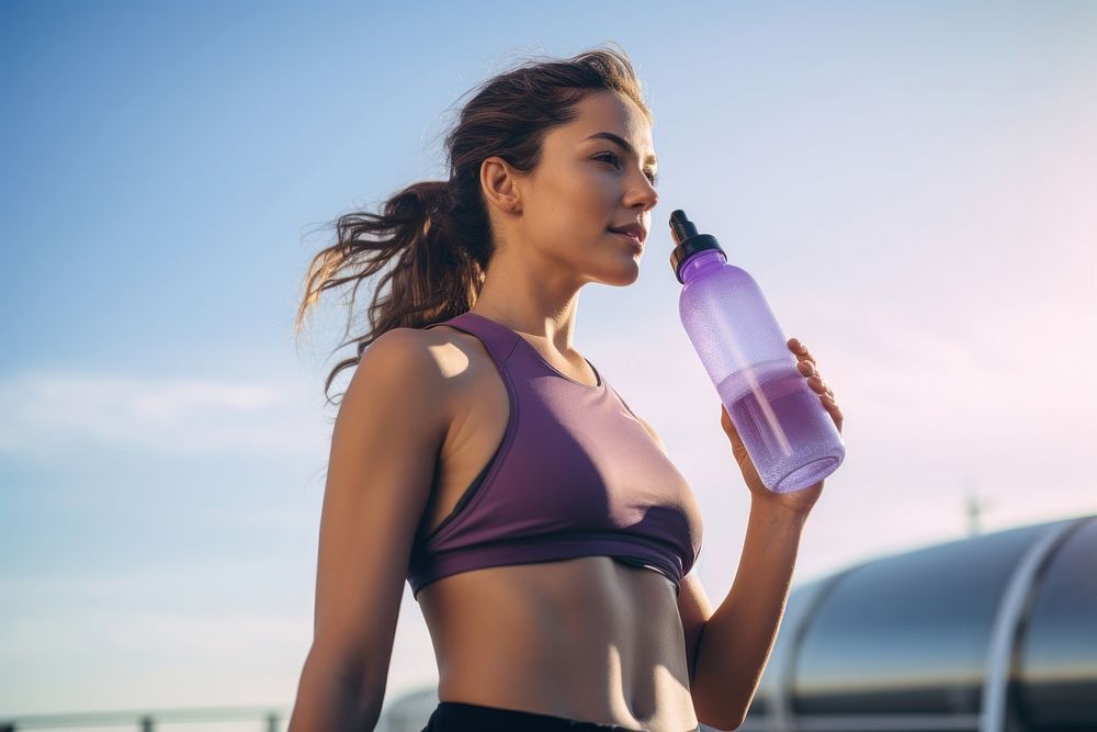 Women holding water bottle purple adult sky.