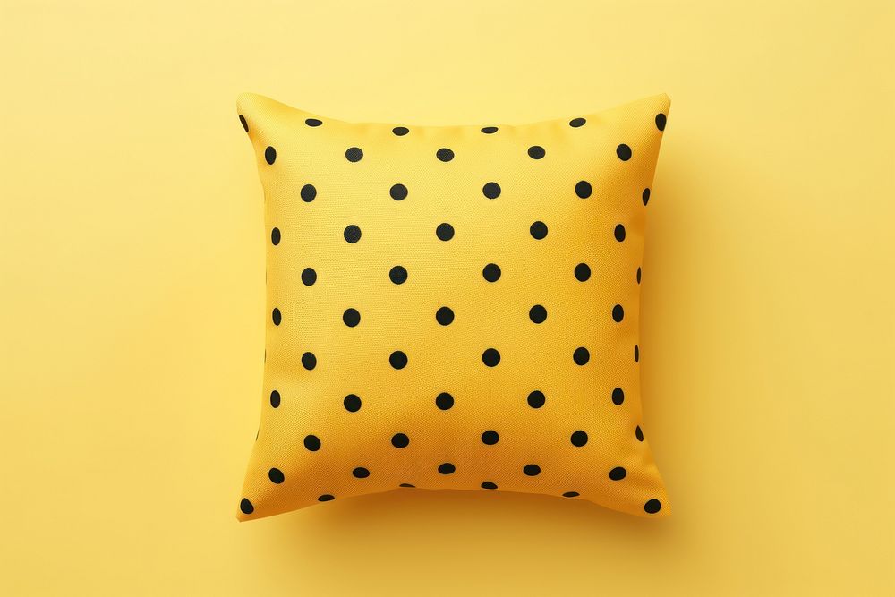 Black polka dot print cushion pillow yellow backgrounds decoration.