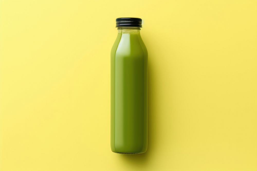 Bottle of green cold pressed juice yellow refreshment container.