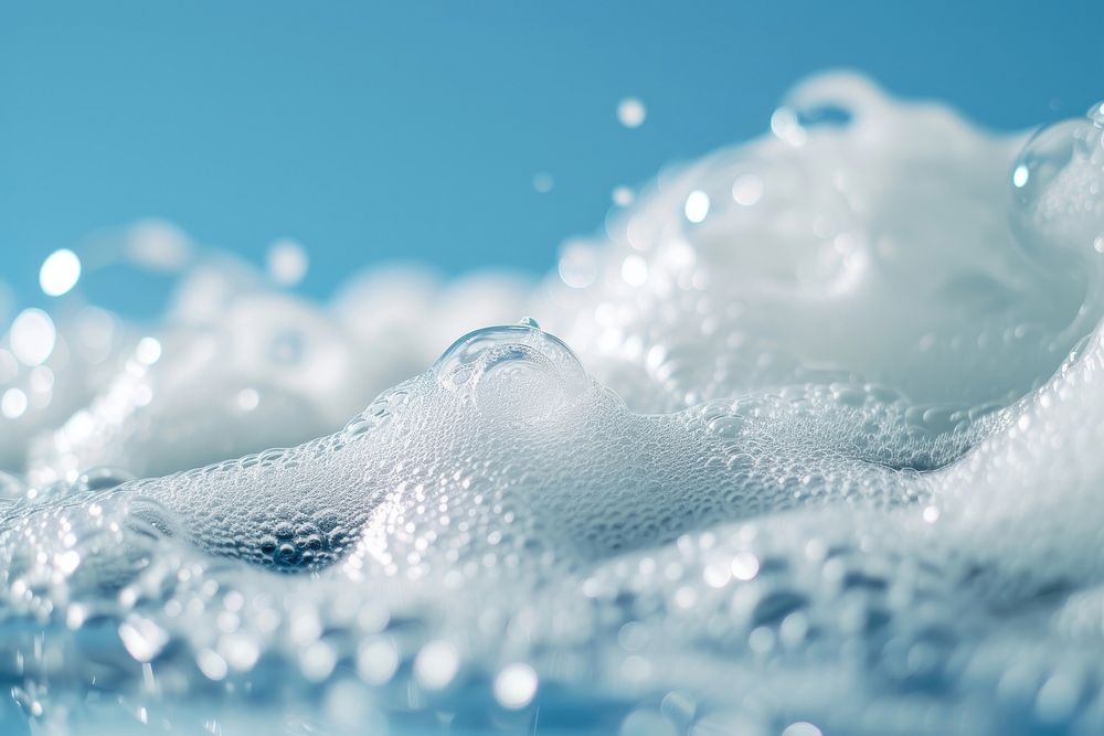 Textured bubbling foam on blue background backgrounds splashing freezing.