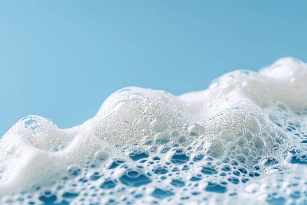 Textured foam on blue background backgrounds splashing freezing.