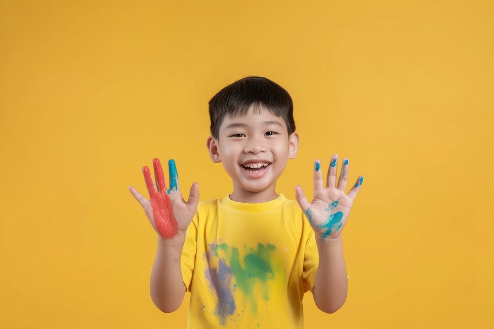 Photo of a smile boy showing child paint.