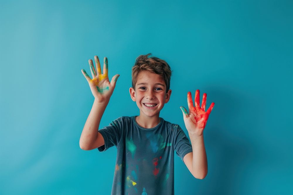 Photo of a smile boy showing paint happy.