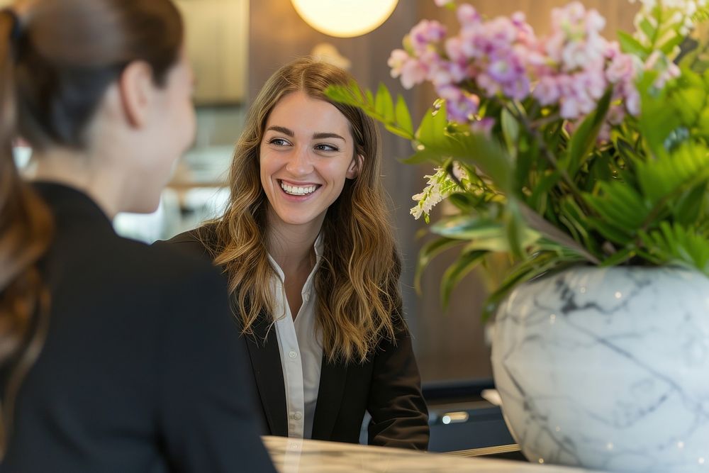 Receptionist and businesswoman at hotel flower adult plant.