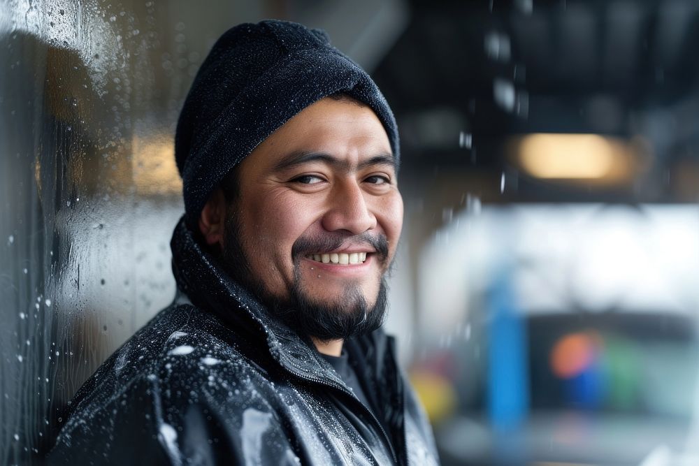 A smiling male hispanic worker in car wash portrait adult smile.