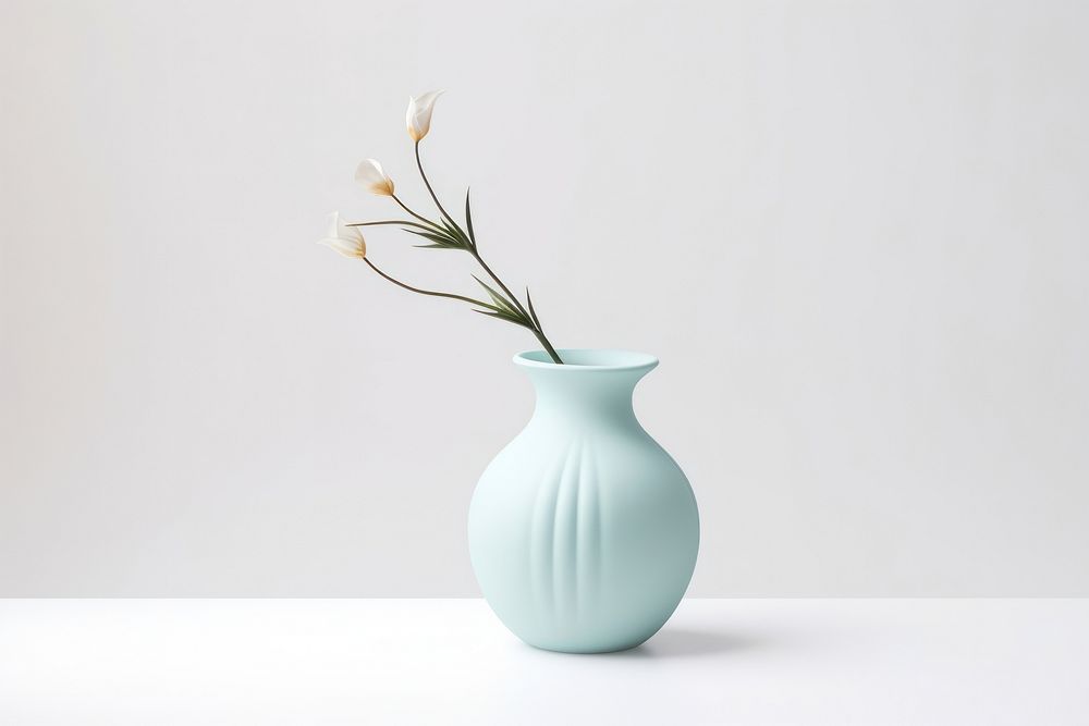 Hand holding a vase pottery flower decoration.