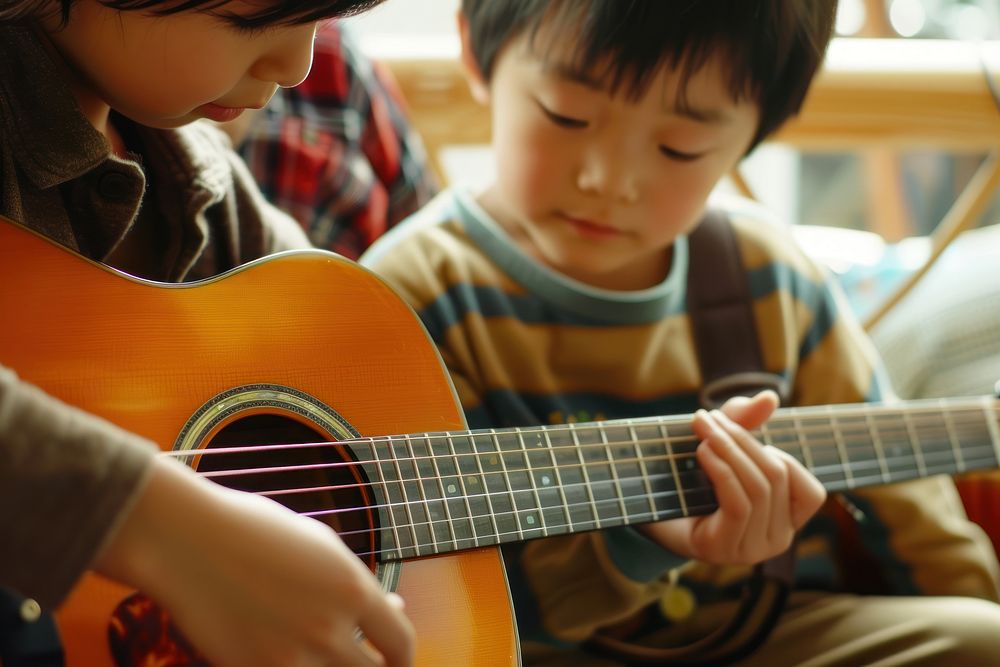 Teaching a guitar musician person child.