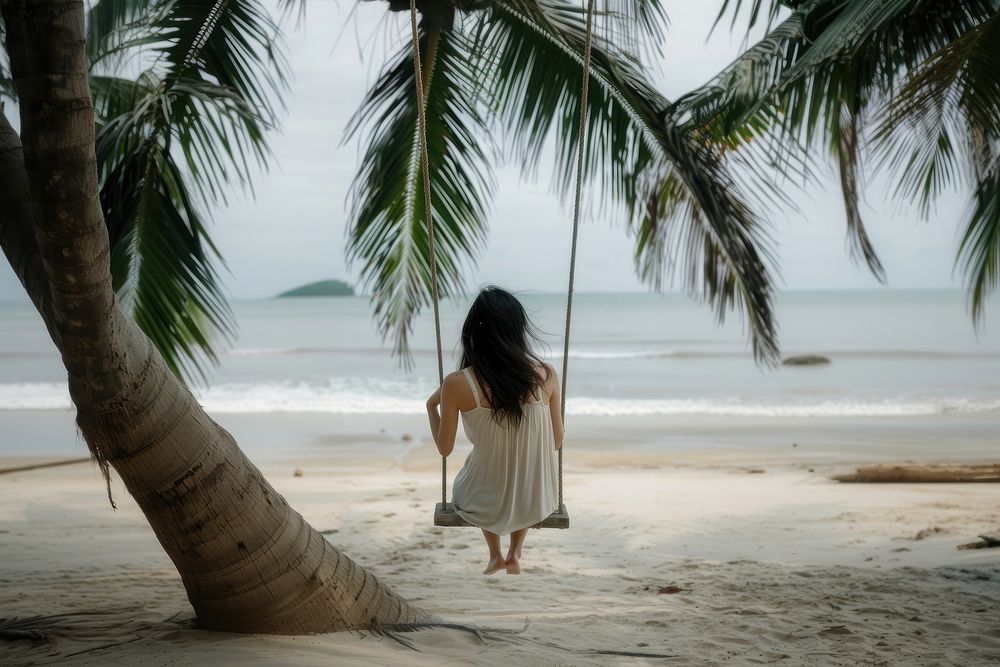 Woman at beach vacation sand tree.