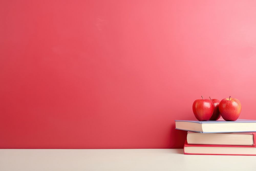 Education light red background publication apple fruit.