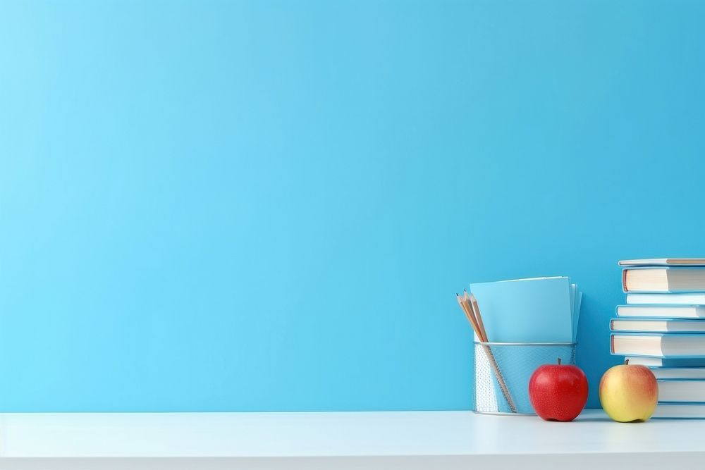 Education light blue background apple fruit red.
