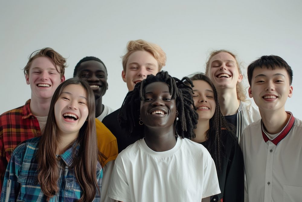 Multiracial group of young people standing in front laughing youth togetherness.