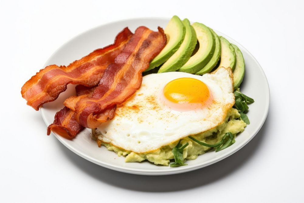 Keto friendly low carb breakfast plate with sunny side up eggs avocado spinach bacon.
