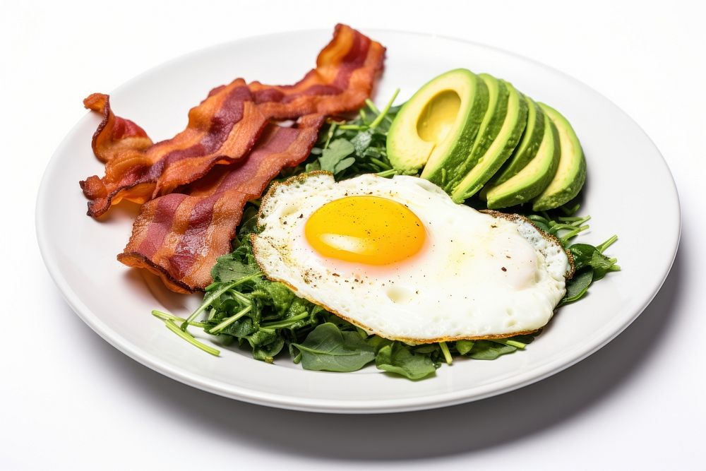 Keto friendly low carb breakfast plate with sunny side up eggs spinach bacon food.