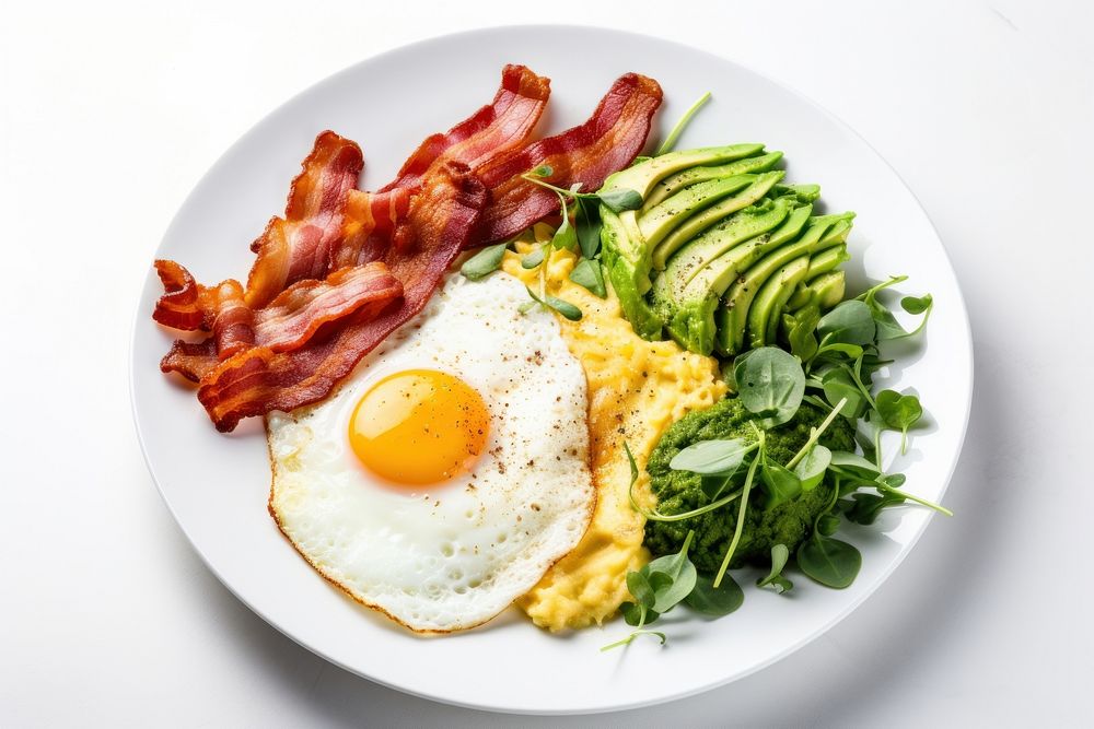 Keto friendly low carb breakfast plate with sunny side up eggs avocado spinach bacon.