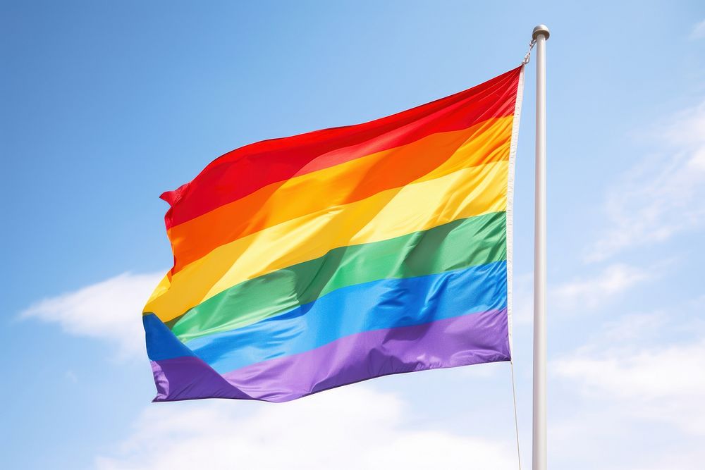Rainbow flag on a pole floating in the wind rainbow pride patriotism.