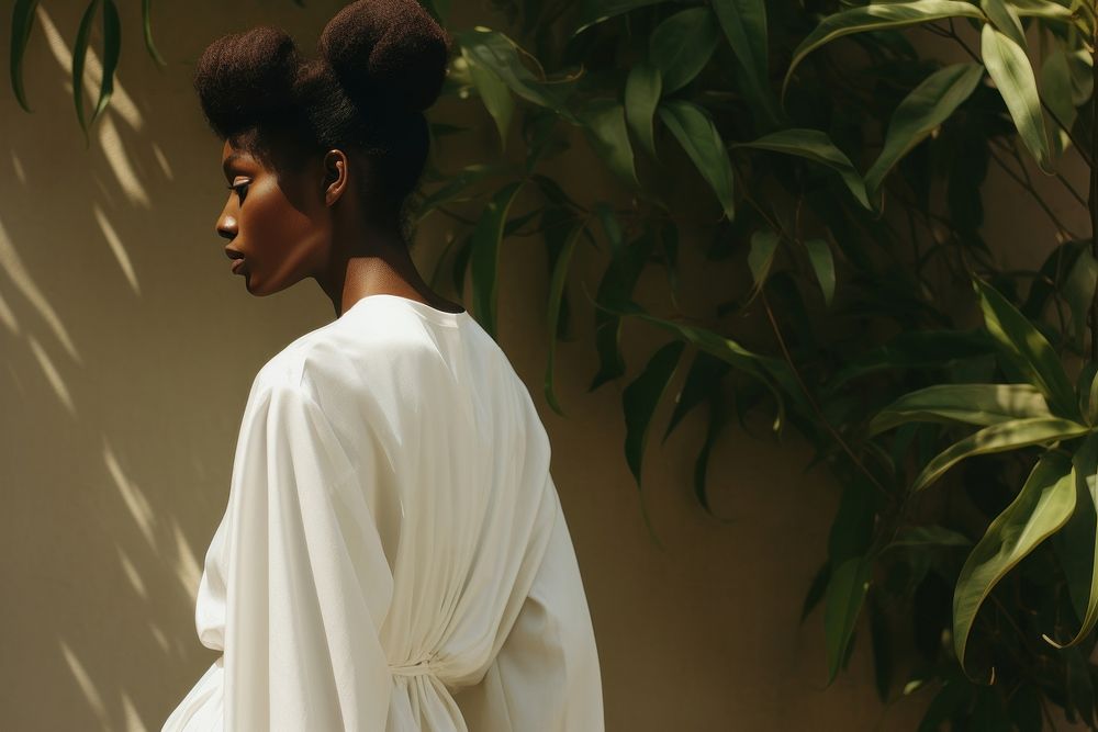 A black woman wearing white modern minimal cloth fashion photography portrait.