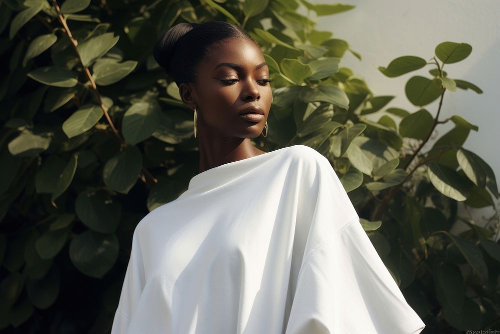 A black woman wearing white modern minimal cloth photography portrait fashion.