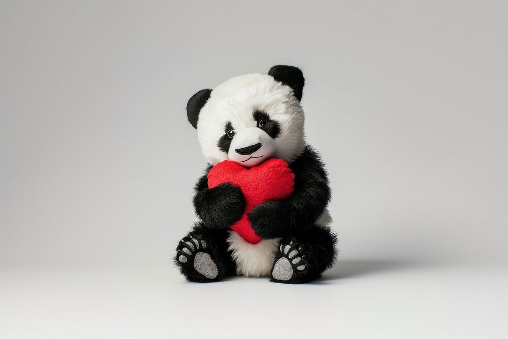 Panda holding heart animal mammal plush.