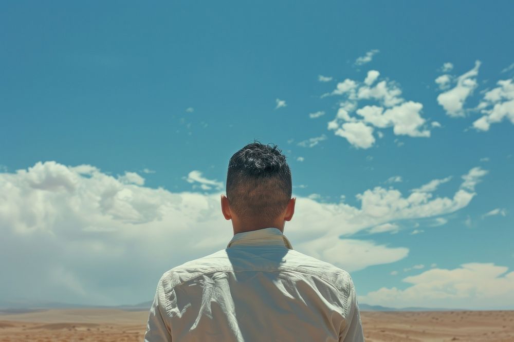 Man standing at desert sky landscape outdoors.