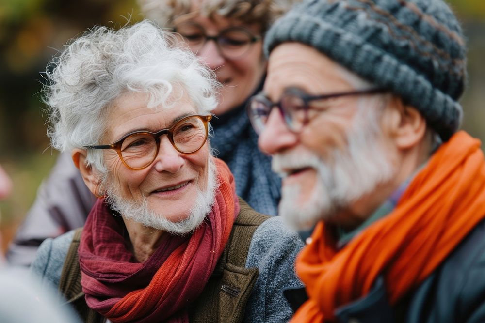 Two diversity cool older interacting with friends laughing glasses scarf.