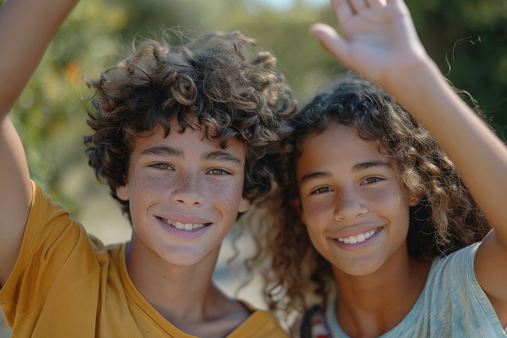 Two diversity cool teens waving photography portrait child.