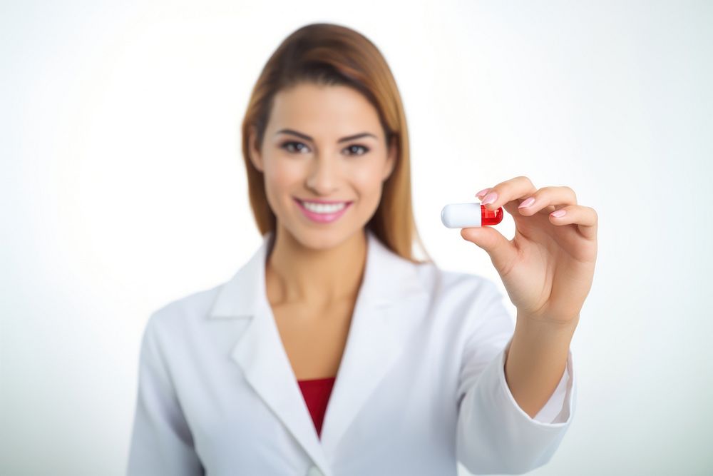 Pharmacist holding pill white background.