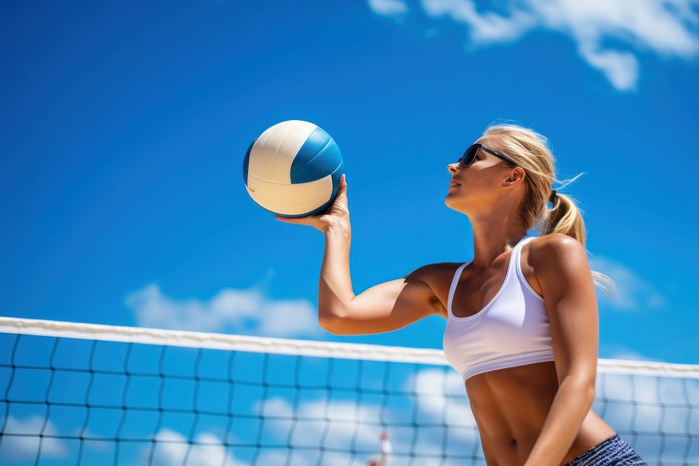 Beach volleyball player in action at sunny day under blue sky sports beach volleyball determination.
