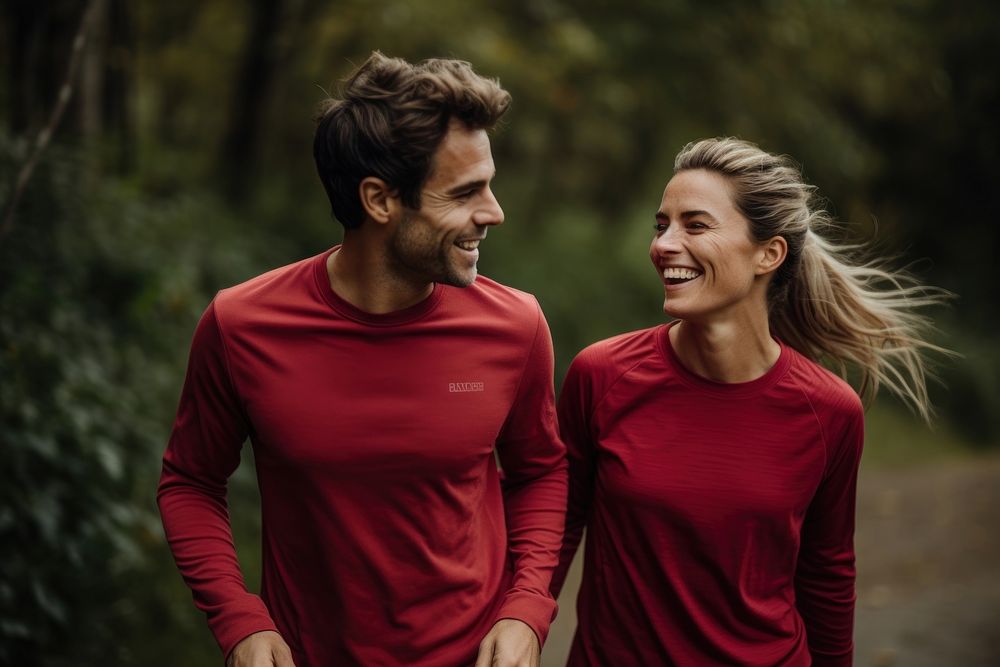 Couple jogging and running outdoors in nature laughing adult determination.