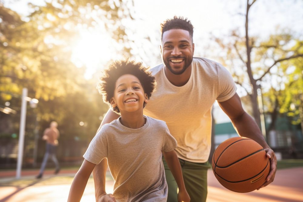 Father and son playing basketball on court sports togetherness friendship.